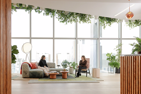 two women sitting and talking