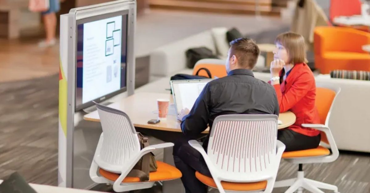 Steelcase hospitality collaboration space with integrated digital displays and guest communication technology