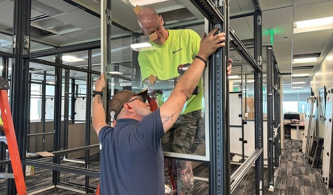 create-spaces-team-installing-glass-wall-panel