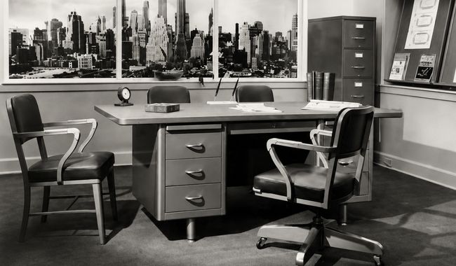 Vintage 1940s office with steel desk, filing cabinet, and city skyline mural